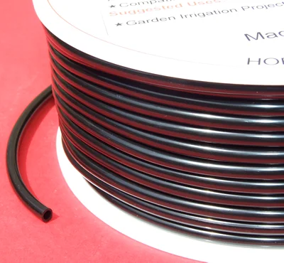 Micro irrigation tube on a white spool/coil on a red background.