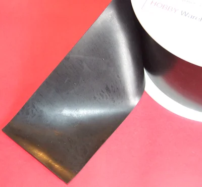 Neoprene rubber sheet on a spool/coil on a red background.