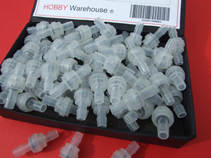 One Way Valves for using with flexible plastic tube in a black display box.