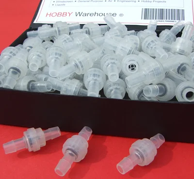 Plastic valves in a black box on a red background.